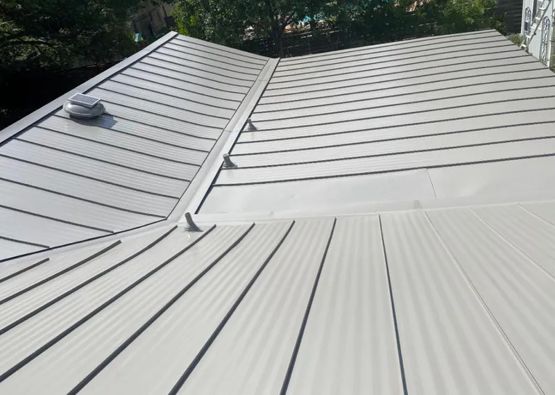 Solar attic fan installed on a metal roof for Roof Ventilation in Bothell East